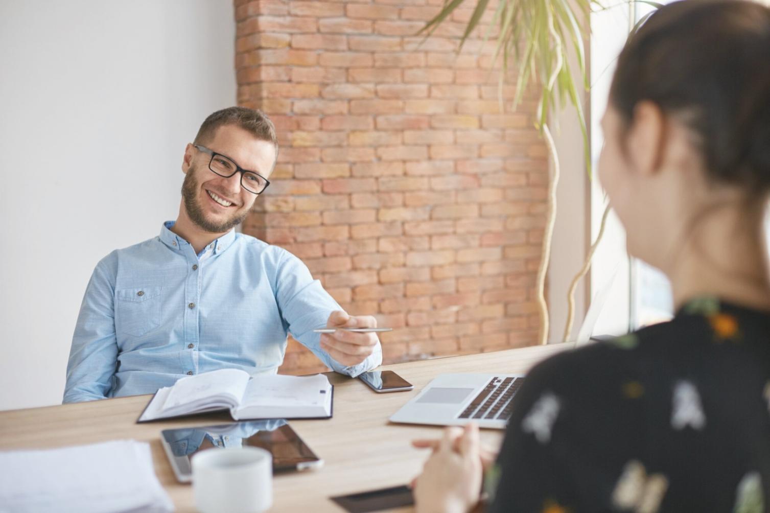 Person reviewing financial documents with calculator and planning materials on desk